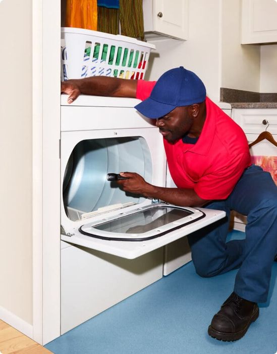 American Home Shield - Man fixing washing machine