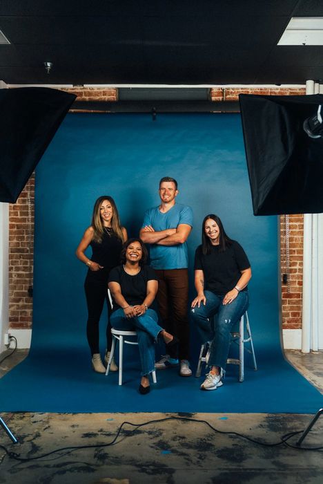 Kit (formerly ConvertKit) - A group of creators sitting and standing together