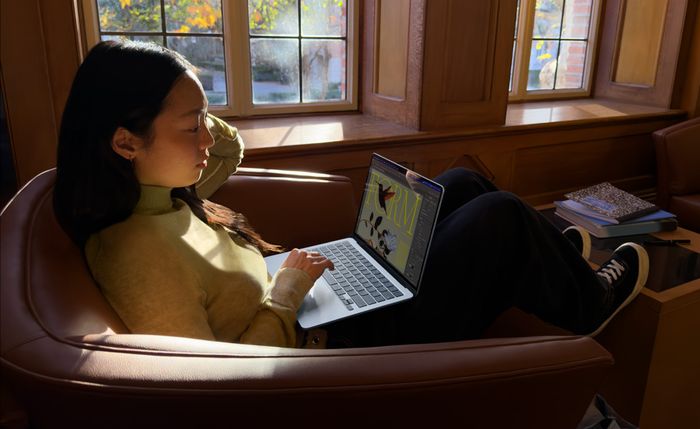 Apple MacBook Air 13" - A person sitting in a chair using their MacBook Air