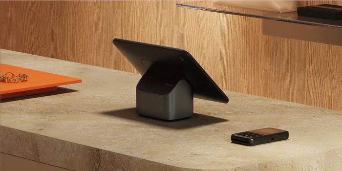 Shopify POS - A tablet mounted on a retail counter with the WisePad 3 sitting next to it.