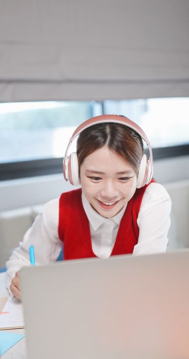 Tutor.com - Smiling educator speaking with colleagues in a school setting